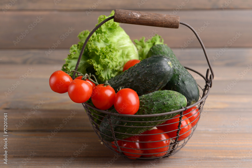 Vegetables in wicker basket on wooden background