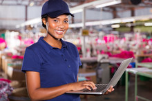 African Factory Supervisor Using Laptop