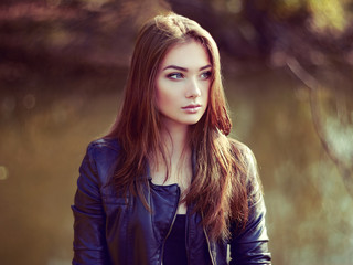 Portrait of young beautiful woman in leather jacket