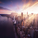 Fototapeta  - New York City - colorful sunset over manhattan with sunbeams