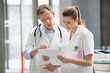 © onoky - Two doctors discussing medical report in hospital