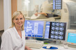 © onoky - Female doctor smiling in medical MRI scan monitor room