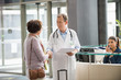 © onoky - Doctor shaking hands with his patient at hospital reception desk