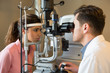 © onoky - Male optometrist examining woman's eyes