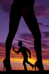 Wall Mural - silhouette cowboy run gun woman legs