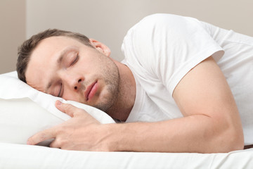 Portrait of sleeping Young Caucasian man in white