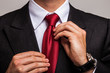 Businessman adjusting his necktie