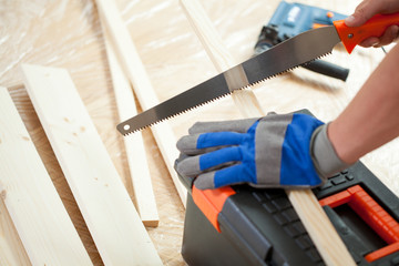 Wall Mural - Using hand saw during house renovation