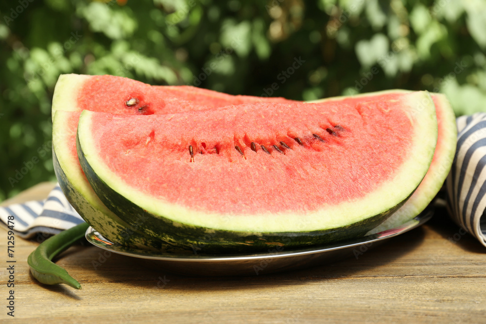 Fresh slice of watermelon on table outdoors, close up