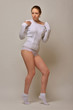 © Dmitriy Raykin - Beautiful woman in white sweater and panties dancing in studio