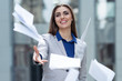 business woman throwing papers on the background of the business