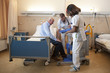 © Betastock - nurses helping a patient out of the bed