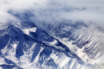  Top view on snow mountains and glacier in mist