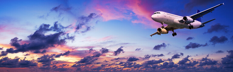 Fototapete - Jet aircraft in a spectacular sunset sky