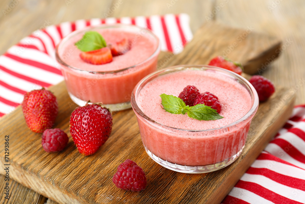 Delicious berry mousse in bowls on table close-up