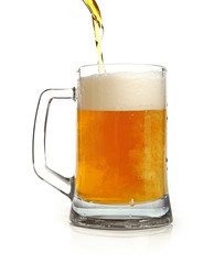 pouring beer in mug isolated on white