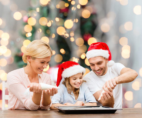 Canvas Print - happy family in santa helper hats cooking