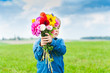 Beautiful bouquet of flowers holding by cute toddler boy