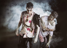 Two Male Zombies Standing On Black Smoky Background