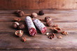 French salami and walnuts on wooden background