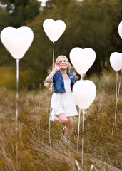 Sticker - portrait of a little girls in a field with white balloons