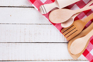 Canvas Print - Wooden spoons, roller on towel on table.