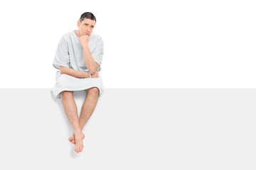 Sticker - Worried male patient sitting on a blank panel