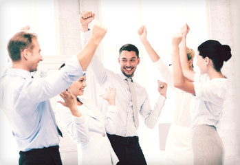 business team celebrating victory in office