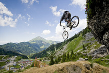 Mountainbiker Jumping From A Rock