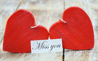 Wall Mural - miss you card with two red wooden hearts