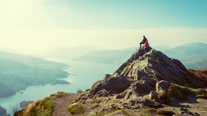 hikers on top of the mountain enjoying view, Highlands, Scotland