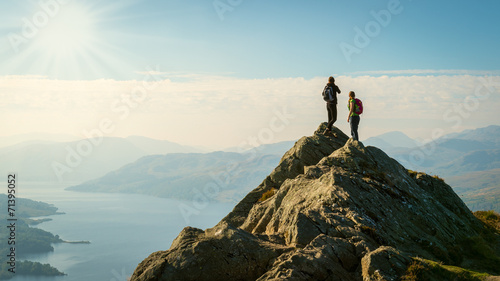 Cuadros en Lienzo hikers on top of the mountain enjoying view, Highlands, Scotland