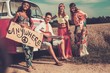 © Nejron Photo - Multi-ethnic hippie hitchhikers with guitar and luggage