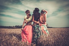 Multi-ethnic Hippie Girls  In A Wheat Field
