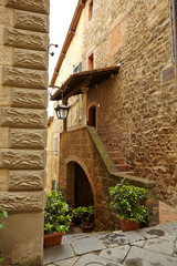 Old small stone medieval street in historical town, Italy