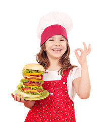 Wall Mural - happy little girl cook with big hamburger and ok hand sign