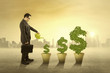 © Creativa Images - Person watering money tree outdoors