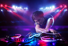 Disc Jockey Playing Music With Light Beam Effects On Stage