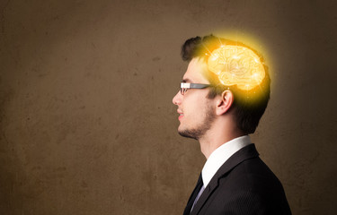 Young man thinking with glowing brain illustration