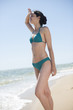 © jackfrog - beautiful young woman in a swimsuit on the beach protecting his