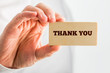 Thank You Text on Small Piece Wood Hold by Hand