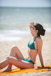 © jackfrog - beautiful woman on the seaside sitting on a beach towel to take