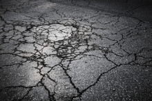 Dark Asphalt Road With Cracks. Background Texture