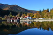 Beautiful fall landscape with a lake house reflected in Saint Ana lake in Tusnad