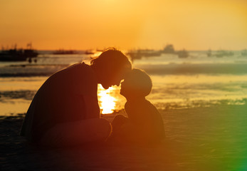 Wall Mural - father and son having fun on sunset beach