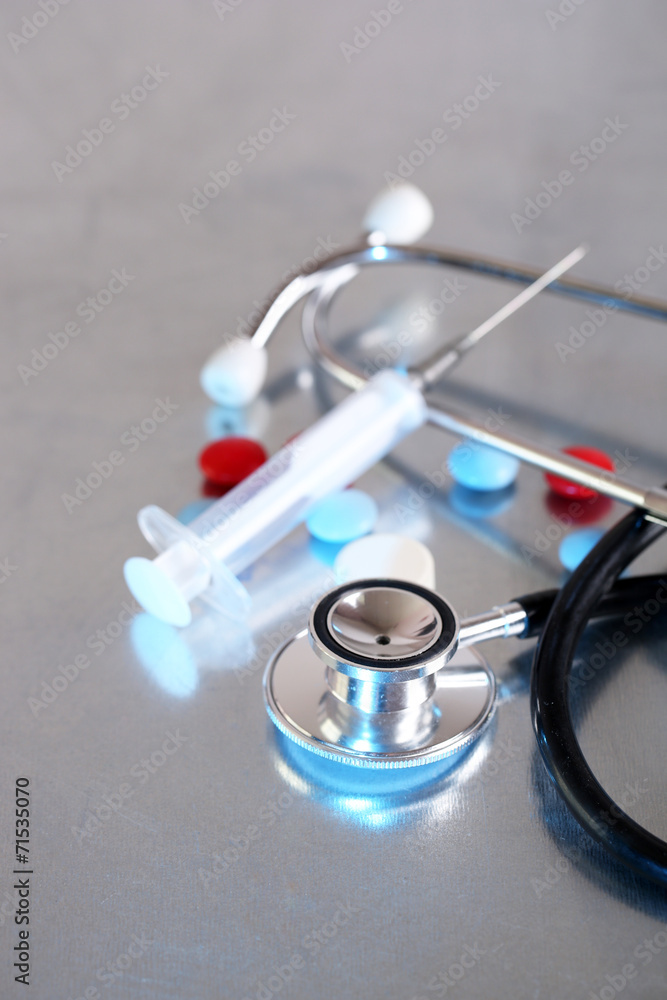 Stethoscope, syringe, pills
