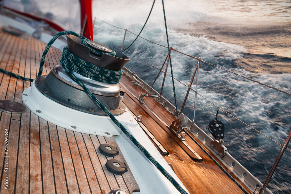 sail boat under the storm, detail on the winch - obrazy, fototapety, plakaty 