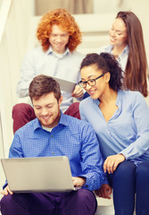 Canvas Print - team with laptop and tablet pc on staircase