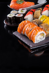 Wall Mural - Sushi pieces on black stone