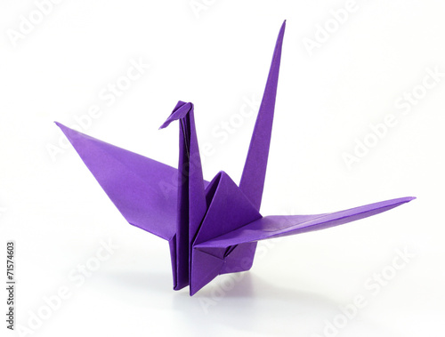 Traditional Japanese Origami Crane Made Of Purple Paper Over